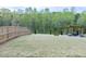 Fenced backyard featuring a patio set with mature trees in the background at 1950 Menet St, Apex, NC 27502