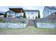 Backyard view with a patio, tiered retaining wall, and stairs leading to the house at 1950 Menet St, Apex, NC 27502