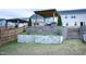 Landscaped backyard with retaining wall, garden, pergola, gazebo, and stair access at 1950 Menet St, Apex, NC 27502