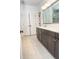Elegant bathroom featuring dual sinks, dark cabinets, and tiled flooring, combining style and functionality at 1950 Menet St, Apex, NC 27502
