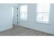 Bedroom with neutral carpet and two windows, providing great natural light at 1950 Menet St, Apex, NC 27502