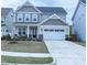 Charming two-story home with a two-car garage and manicured front lawn at 1950 Menet St, Apex, NC 27502