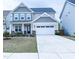 Charming two-story home with a two-car garage and manicured front lawn at 1950 Menet St, Apex, NC 27502