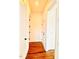 Hallway showcasing hardwood flooring and white doors, connecting various rooms in the home at 1950 Menet St, Apex, NC 27502