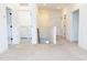 Bright hallway featuring neutral carpet, white walls, and a convenient laundry room, creating a clean and inviting space at 1950 Menet St, Apex, NC 27502