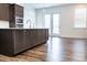 Bright kitchen featuring dark cabinetry, a center island, and stainless steel appliances at 1950 Menet St, Apex, NC 27502