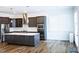 Bright kitchen featuring dark cabinetry, a center island, and stainless steel appliances at 1950 Menet St, Apex, NC 27502