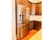 Gourmet kitchen featuring stainless steel refrigerator, custom cabinets, and sleek countertops at 1950 Menet St, Apex, NC 27502