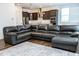 Open floorplan from living room to kitchen with an island bar, black cabinets, and stainless steel appliances at 1950 Menet St, Apex, NC 27502