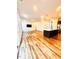 Open concept living space featuring hardwood floors, TV, and an open concept kitchen at 1950 Menet St, Apex, NC 27502