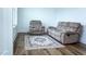Cozy living room featuring a comfortable couch and armchair set on a stylish rug at 1950 Menet St, Apex, NC 27502