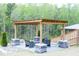 Outdoor living space featuring a patio with chairs and a table beneath the shelter at 1950 Menet St, Apex, NC 27502