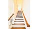 Hardwood staircase with white risers and a wooden handrail at 1950 Menet St, Apex, NC 27502