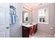 Bathroom featuring double sink, window with natural light, and decorative mirror at 212 Mickleson Ridge Dr, Raleigh, NC 27603