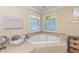 Cozy bathroom featuring a soaking tub with natural light from the window at 212 Mickleson Ridge Dr, Raleigh, NC 27603