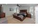 Comfortable bedroom with a large bed, ceiling fan, and two bright windows at 212 Mickleson Ridge Dr, Raleigh, NC 27603
