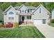 Charming two-story home with well-manicured lawn and attached two-car garage at 212 Mickleson Ridge Dr, Raleigh, NC 27603