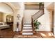 Grand foyer with elegant staircase, hardwood floors, and a view of the upper level at 212 Mickleson Ridge Dr, Raleigh, NC 27603