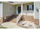 Welcoming front porch with brick steps and a decorative railing, perfect for relaxing at 212 Mickleson Ridge Dr, Raleigh, NC 27603