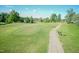 Scenic view of a golf course with lush green fairways and mature trees offering a tranquil and picturesque setting at 212 Mickleson Ridge Dr, Raleigh, NC 27603