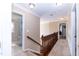 Hallway with wood railing leads to bathroom and bedrooms at 212 Mickleson Ridge Dr, Raleigh, NC 27603