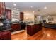 Modern kitchen with dark wood cabinets, granite countertops, and stainless steel appliances at 212 Mickleson Ridge Dr, Raleigh, NC 27603