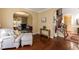 An inviting living room featuring hardwood floors, neutral paint, and a comfortable ottoman with couch seating at 212 Mickleson Ridge Dr, Raleigh, NC 27603