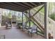 Covered deck with stone fireplace, ceiling and wood floor creates an inviting outdoor living space at 2317 Rainy Lake St, Wake Forest, NC 27587