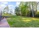 Expansive backyard features a well-maintained lawn, mature trees, and terraced landscaping leading to the house at 2317 Rainy Lake St, Wake Forest, NC 27587