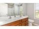 Bright bathroom features a double sink vanity with a large mirror and a walk-in shower at 2317 Rainy Lake St, Wake Forest, NC 27587