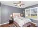 Comfortable bedroom with hardwood floors, a decorative headboard, and a view of the neighborhood at 2317 Rainy Lake St, Wake Forest, NC 27587
