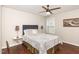 Bedroom with hardwood floors, ceiling fan, and a cozy queen-size bed with decorative pillows at 2317 Rainy Lake St, Wake Forest, NC 27587