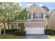 Charming two-story brick home with a well-manicured lawn and a two-car garage at 2317 Rainy Lake St, Wake Forest, NC 27587