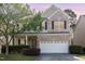 Charming two-story home featuring a brick facade, attached two-car garage, and well-manicured landscaping at 2317 Rainy Lake St, Wake Forest, NC 27587