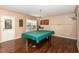 Basement game room features a pool table with green felt, perfect for entertaining friends and Gathering at 2317 Rainy Lake St, Wake Forest, NC 27587
