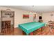 Spacious game room features a pool table, bar area, and comfortable seating, ideal for relaxation and entertainment at 2317 Rainy Lake St, Wake Forest, NC 27587