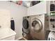 Modern laundry room featuring a front load washer and dryer, sink, and storage for efficient laundry care at 2317 Rainy Lake St, Wake Forest, NC 27587