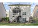 Rear exterior view features an elevated deck, a screened porch and a stone fireplace for outdoor living at 2317 Rainy Lake St, Wake Forest, NC 27587