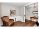 Cozy sitting room featuring hardwood floors, chair rail, and a comfortable striped armchair at 2317 Rainy Lake St, Wake Forest, NC 27587