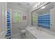 Bright bathroom featuring a shower, vanity, framed mirror, and a window providing natural light at 2520 Ashley Ct, Raleigh, NC 27607