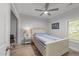 Bright bedroom with hardwood floors, white bed frame, and blue striped bedding and natural light at 2520 Ashley Ct, Raleigh, NC 27607