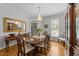 Bright dining room featuring a wooden table, decorative china cabinet, chandelier, and a large mirror at 2520 Ashley Ct, Raleigh, NC 27607