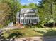 Beautiful two-story home with black shutters and dormers surrounded by mature trees at 2520 Ashley Ct, Raleigh, NC 27607
