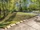 Landscaped exterior view of a home's driveway surrounded by mature trees and greenery at 2520 Ashley Ct, Raleigh, NC 27607