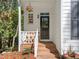 Charming front porch with brick steps and white railings, offering a cozy entrance to the home at 2520 Ashley Ct, Raleigh, NC 27607