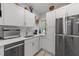 Modern kitchen featuring white cabinets, stainless steel appliances, and natural light at 2520 Ashley Ct, Raleigh, NC 27607