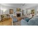 Elegant living room with a brick fireplace, hardwood floors, and sophisticated furnishings at 2520 Ashley Ct, Raleigh, NC 27607