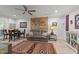 A fully furnished living room with a leather couch, wooden dining set, ceiling fan, and a world map wall decoration at 2520 Ashley Ct, Raleigh, NC 27607