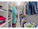 Bright walk-in closet with clothing, colorful hangers, and neatly organized shelves, offering ample storage space at 2520 Ashley Ct, Raleigh, NC 27607