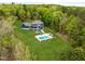 Aerial view of a beautiful estate home with an in-ground pool surrounded by lush landscaping at 255 Seven Island Rd, Pittsboro, NC 27312